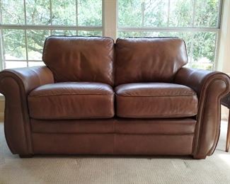 brown leather love seat