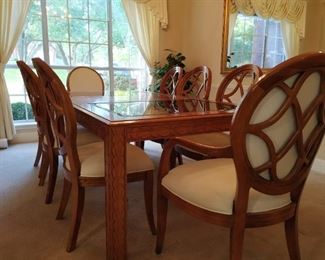 Formal dining table and six chairs, glass inset, carved legs, 84" long shown with one leaf, 44" wide, comes with additional 17" leaf