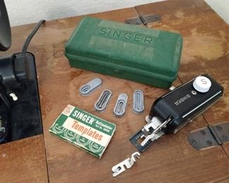 Singer sewing machine and storage cabinet with accessories and assorted presser feet. Includes buttonholer kit.