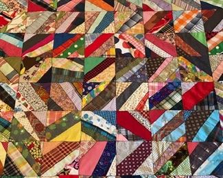 Scrappy strips table topper. Zigzag machine stitch. Crocheted border of crosses. Unlined back. 95” x 75”.