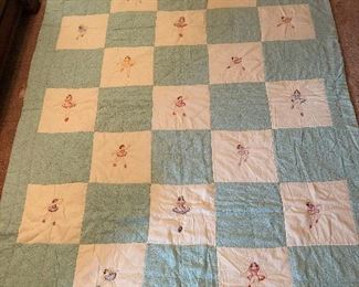Embroidered ballerina quilt. Hand quilted, some machine work, hand embroidery. Five different poses. Tiny flowers on pale aqua trim and backing. 82” x 63”.