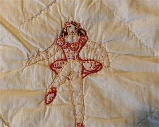 Embroidered ballerina quilt. Hand quilted, some machine work, hand embroidery. Five different poses. Tiny flowers on pale aqua trim and backing. 82” x 63”.