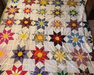 Amazing three-dimensional sunflower topper. 4 inch yellow border with Ila trim. Hand quilted with machine stitch hand appliquéd, three dimensional work. 117” x 96”