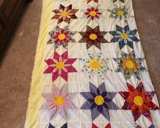 Amazing three-dimensional sunflower topper. 4 inch yellow border with Ila trim. Hand quilted with machine stitch hand appliquéd, three dimensional work. 117” x 96”