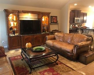 Lighted entertainment center, down leather sofa, wrought iron cocktail table