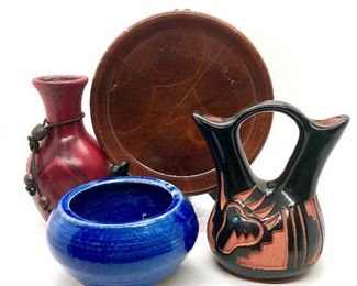 Assortment of Native American and handcrafted pottery.