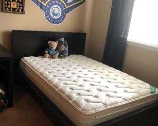 Full sized platform bed with mattress.