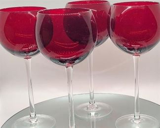 Red long stemmed Lenox goblets.