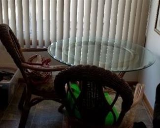 Glass-top kitchen table with 4 rattan chairs