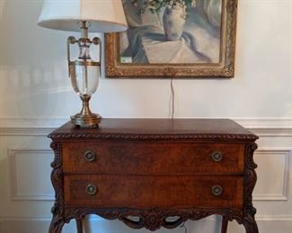 One of a pair of antique, nicely carved French 2-drawer chests, with solid crystal/brass Decorative Crafts table lamps and hand painted oil on canvas, by John Thomaston, dated 1932.