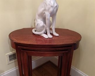 Set of vintage English mahogany nesting tables, with pencil and checkerboard inlay, guarded by fierce ceramic whippet.