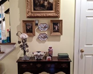 Antique 2-drawer mahogany console table, with original brasses, art deco metal female figurine table lamp, with MOP shell shade, nice vintage Asian porcelains, pair of Asian octagonal plates, trio of important European oils on canvas.