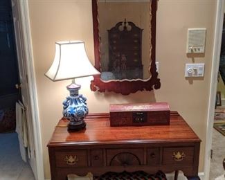 Interesting mahogany console table, by White Furniture Co, Mebane, NC. , vintage mahogany/gold wall mirror, Chippendale bench, Asian blue/white porcelain table lamp and wooden Asian box.