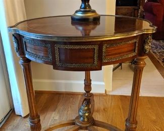 Excellent French mahogany single-drawer round table, with bronze mounts and inlaid top.