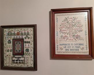 A pair of the collection of vintage, hand made, cross-stitched samplers.