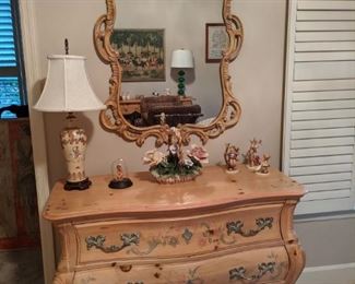 Hand painted, three-drawer contemporary bombé pine chest, with matching mirror, Asian porcelain table lamp and collection of Hummel figures. 