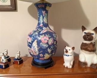 One of a pair of Asian porcelain table lamps, vintage porcelain Siamese cats and Limoges porcelain cat boxes.