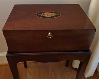 Nicely inlaid shell detail on mahogany box, on stand.