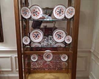 One of a pair of Pulaski Furn. Co. lighted curio cabinets, with Royal Crown Derby English porcelains and Baccarat figurine collection.