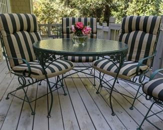 One of two sets of vintage wrought iron outdoor furniture.                                                                                                 The armchairs gently rock and the cushions are by Better Homes & Gardens - magazine subscription not included...