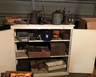 Cabinet and oil cans