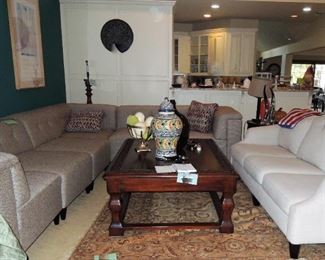 Large sectional sofa - made of individual pieces. Large wood coffee table. Medallion art. Ceramic urns and ostrich eggs