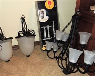 Contemporary, large pendant lights and chandelier. Several flat screen tv wall mounts