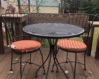 Patio table, two chairs, and seat cushions