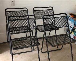 Four metal folding chairs