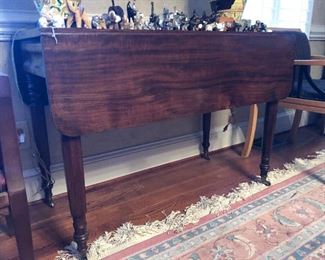 Early double dropleaf table w/ metal wheels one drawer