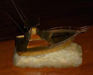 Brass fishing boat mounted on marble