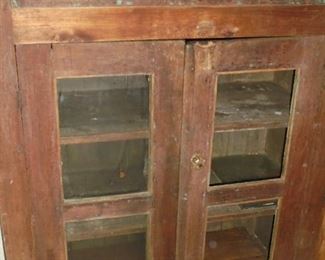 Primitive kitchen cabinet w/glass knobs & original glass (2 of 4 panes) indoors 