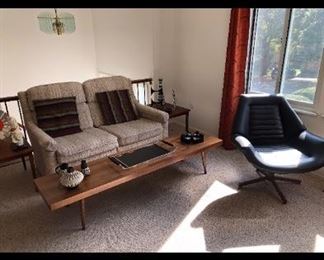 Extra-Long Unmarked Coffee Table, Sleeper Sofa, "Control Room" Swivel Chair 