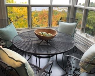 Another view of the wrought iron table. Shown with hand carved wooden bowl and down pillows. Pillows sold separately 