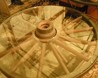 AMAZING coffee table made from an authentic 1800's wagon wheel with glass top. Truly exceptional!! You must see this!
