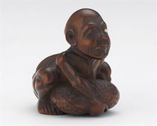 Japanese Carved Boxwood OneEyed Spirit and Stone Signed Netsuke 