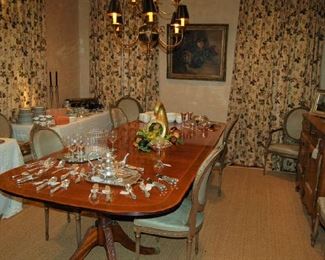 Beautiful double-banded, triple pedestal banquet table with leaves; curtains also for sale