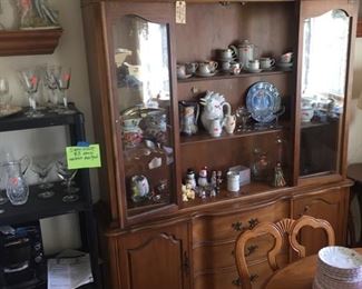 shot of stuff in china hutch-Italian pottery-good glass-dining table with 6 chairs