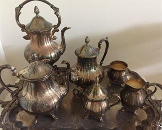 A 6-piece silver plated tea set by Sheridan Taunton Silversmiths: Tray, 3 coffee and teapots, cream and sugar. Tray: Width: 31. Depth: 18".