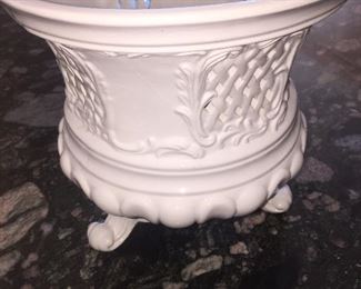 A white ceramic plant holder
