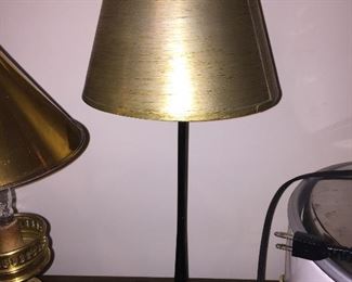 A lamp with gold colored shade