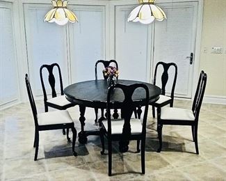 $100 for table. Black round wood dining table with four leaves that extends to oval table. Solid and heavy. Round Table Diameter: 52 inches. Oval Table Diameter Width 51 x Length 95 x Height 29".  6 dining chairs sold together or separately. $40 per chair. 