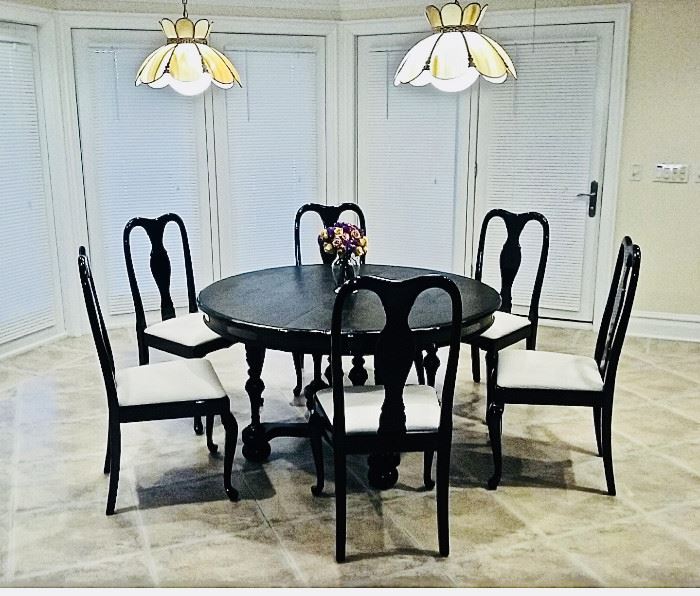 $100 for table. Black round wood dining table with four leaves that extends to oval table. Solid and heavy. Round Table Diameter: 52 inches. Oval Table Diameter Width 51 x Length 95 x Height 29".  6 dining chairs sold together or separately. $40 per chair. 