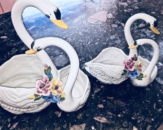 A pair of swan plant holders