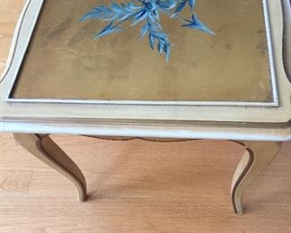 A pretty square table with gold leafing top, curved legs