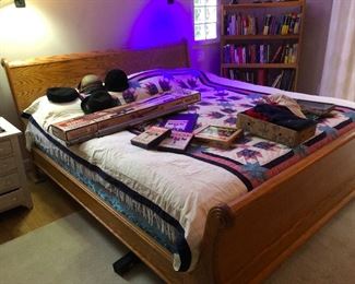 King sleigh bed sporting vintage hats