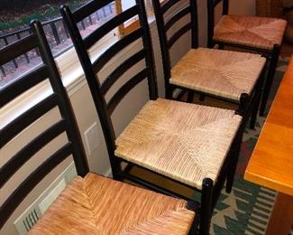 four chairs with grass skirts all in a wad