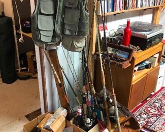 Fishing poles and fishing vest and red bottle