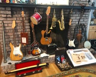 Sold. Fireplace mantle full of guitars, trumpets, drums and is that a bassoon?? 