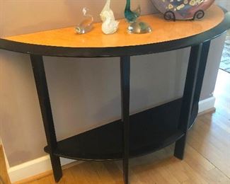 demi lune table with flock of glass geese wondering which one laid that giant egg